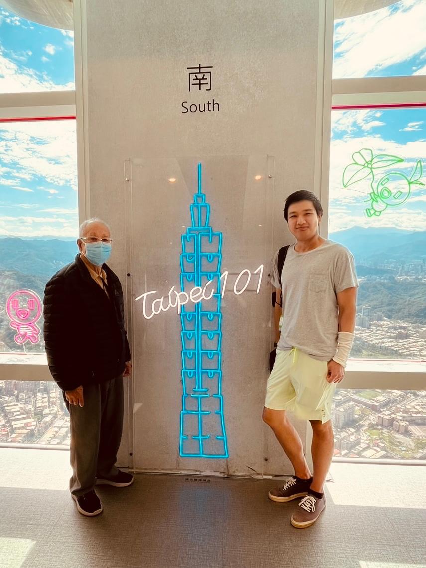 Justin (right) with his grandfather at the Taipei 101 observation deck